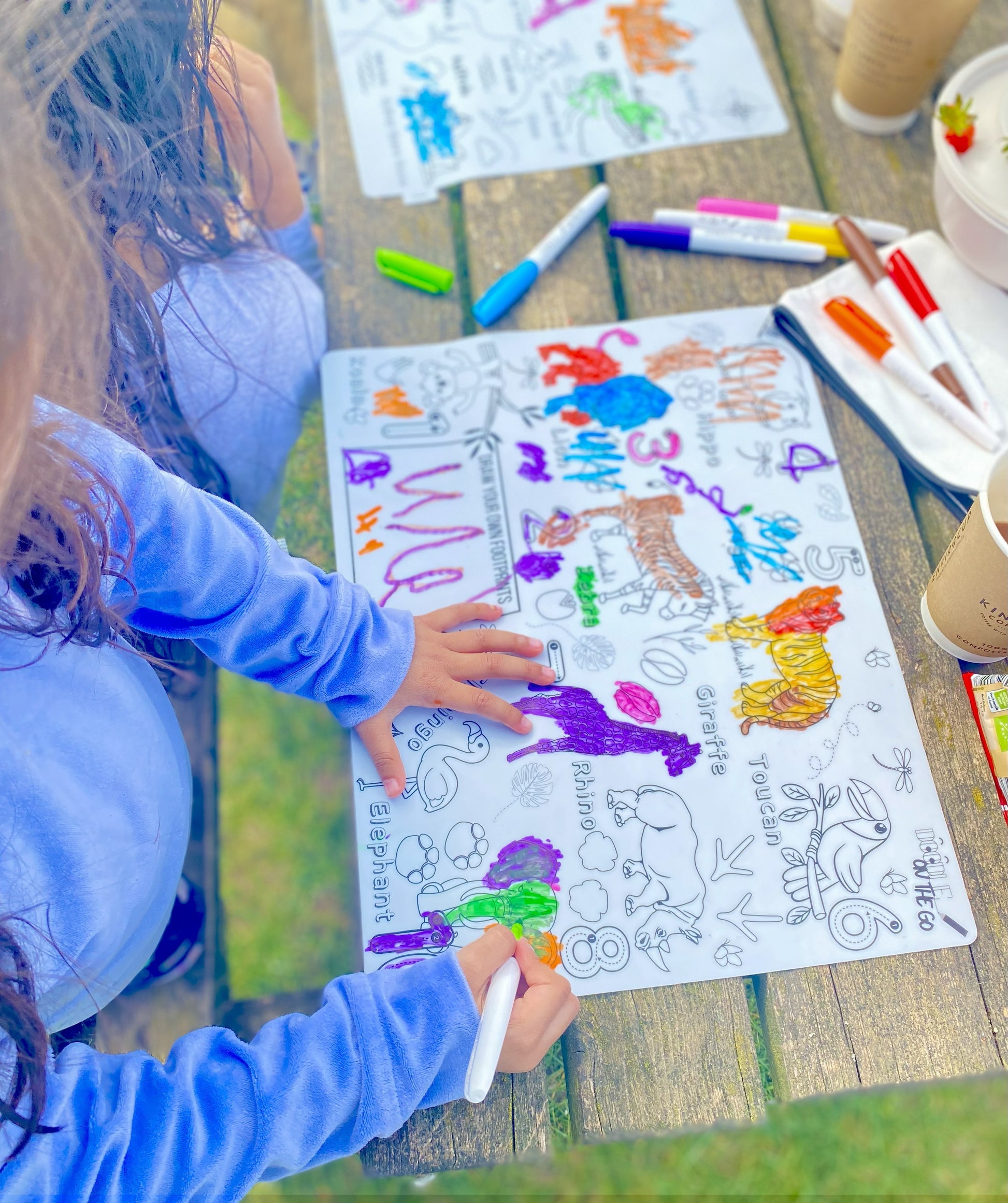 Kids learning animal footprints and drawing their own on reusable mat