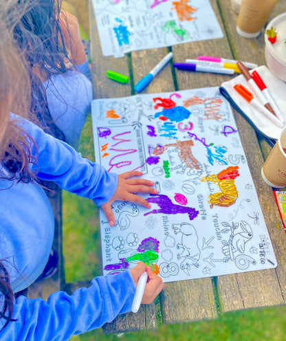 Child using a reusable kids doodle mats for outdoor colouring