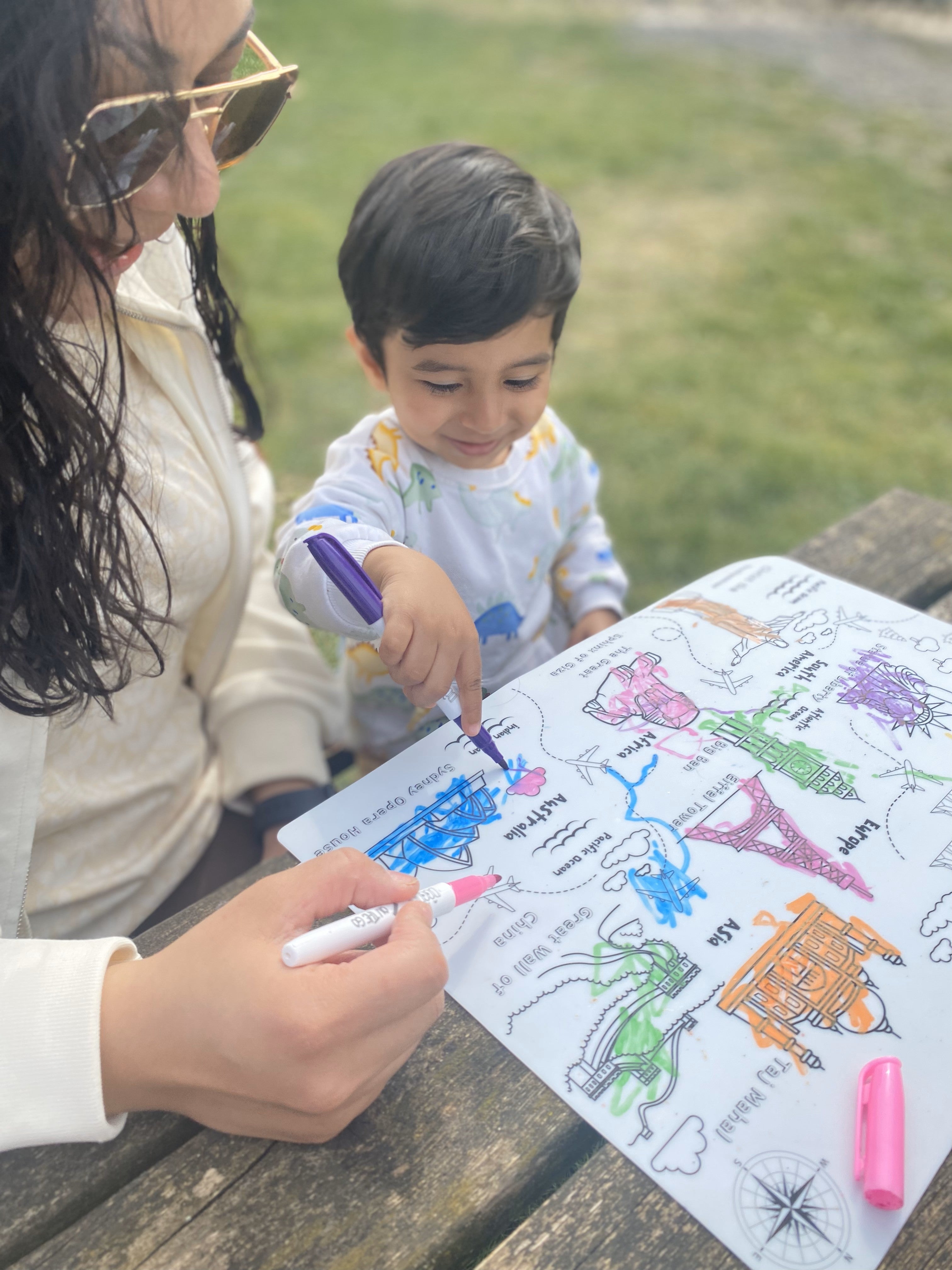 Parent and child enjoying screen-free colouring together using a reusable silicone activity mat